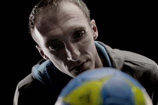 Ein Handballer guckt einen Erima Handball an