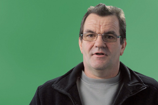 Ein älterer Futura Mitarbeiter vor einem Greenscreen
