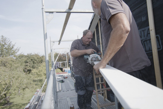 Handwerker benutzen eine Säge