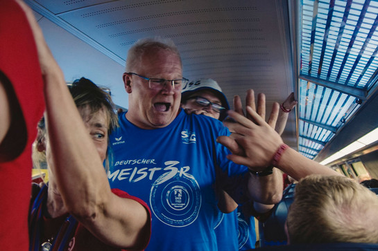bb_sonderzug_teaser_05.jpg Ein SG Fans gibt einem anderem Fan ein high five