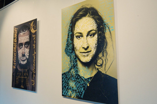 Zwei große Portraits von Gesichtern,  die mit Worten und Symbolen versehen sind