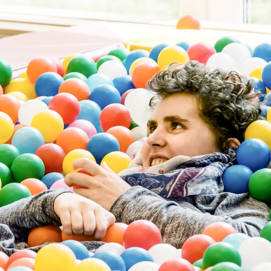 Eine Frau liegt zwischen Bällen