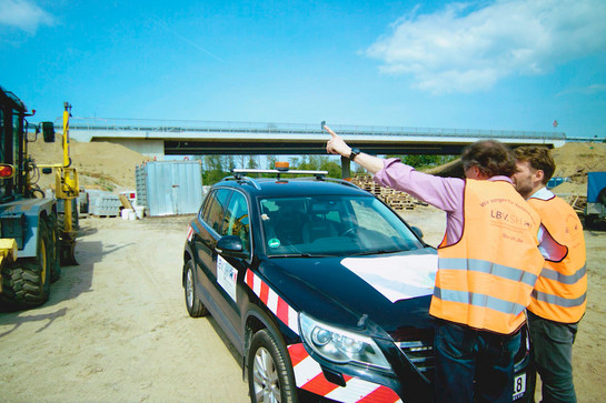 Ein schwarzes Auto steht auf einer Baustelle