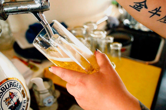 Eine Fra schenkt Bier ein