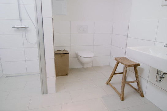 Ein modernes weißes Bad mit Holzmöbeln