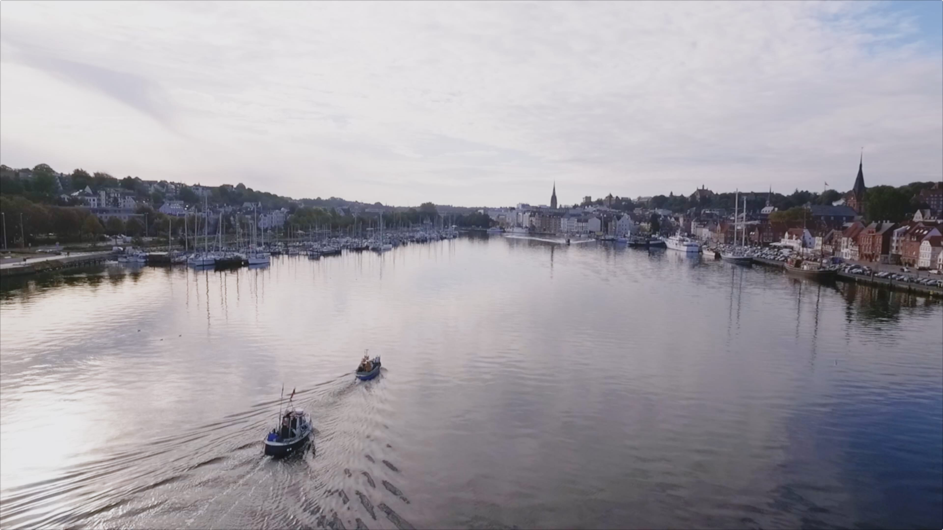 Zwei Boote fahren in den Flensburger Hafen ein